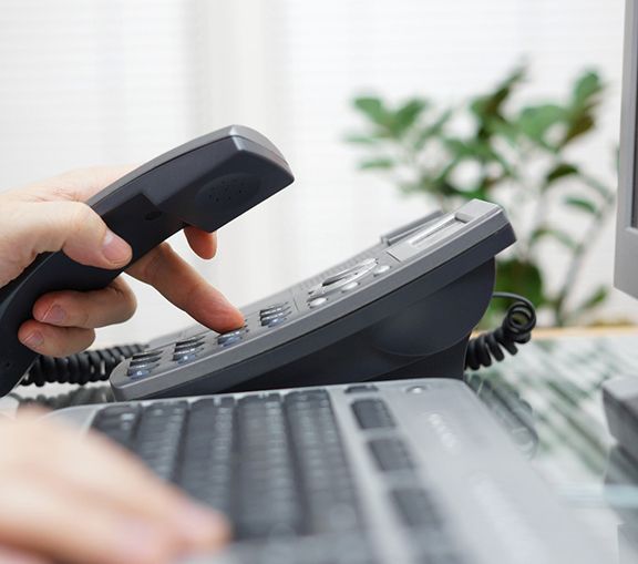 Person in office preparing to make a phone call