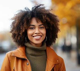 Woman wearing orange jacket and smiling