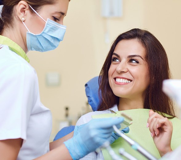 Smiling woman talking to her dentist