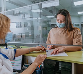 Greenville patient reviewing financing for Dental Crowns