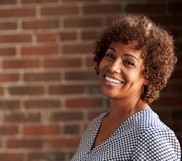 Woman smiling with dental bridges in Greenville