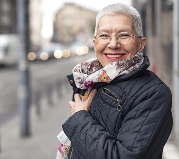 Woman smiling in city with dentures in Greenville