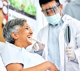 Patient smiling at reflection in mirror