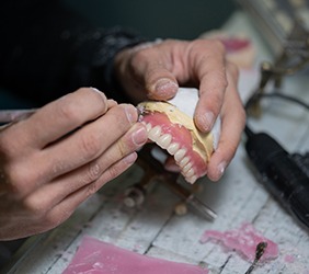 Lab technician carving dentures