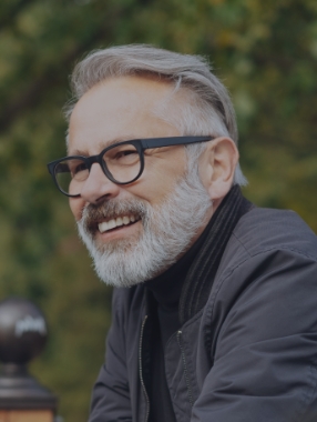 Older man with glasses and gray beard