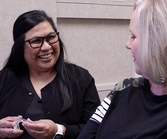 Greenville dental team member smiling with dental patient