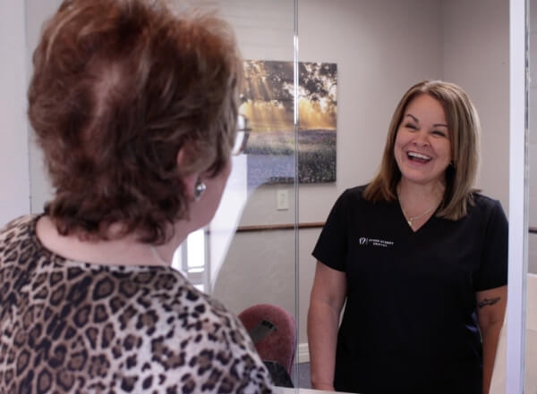 Greenville dental team member smiling at dental patient