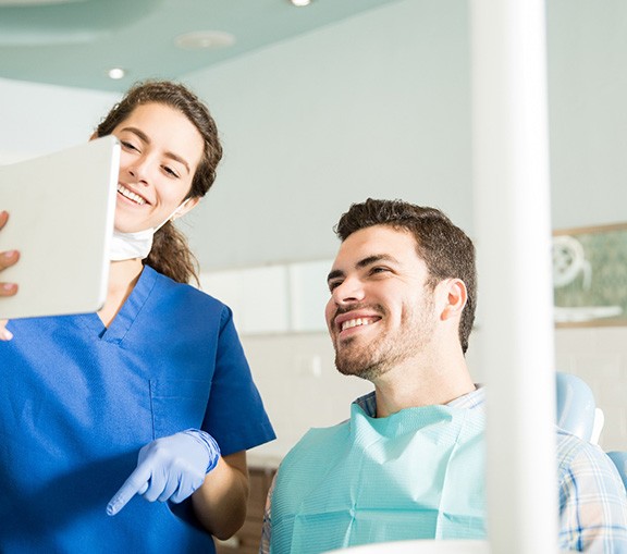 Dental hygienist explains something to patient