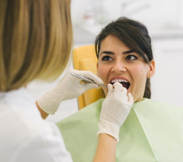 Woman receiving preventive dentistry checkup and teeth cleaning