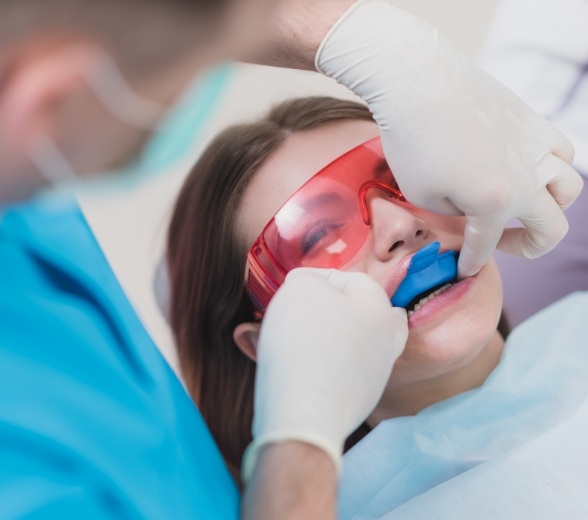 Young woman receiving fluoride treatment