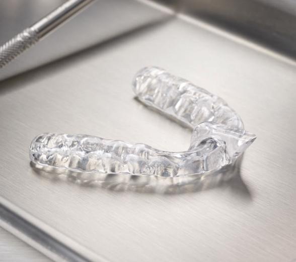 Clear nightguard for teeth grinding on metal tray