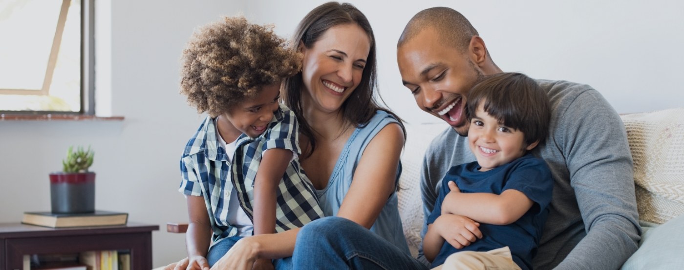 Family of four smiling after receiving dental services in Greenville Texas