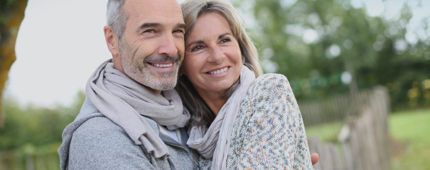 Older couple smiling together outdoors