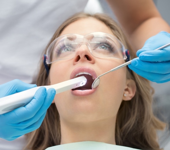 Dentist using intraoral camera to capture photos of a patients mouth