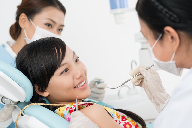 teenager smiling while visiting dentist 