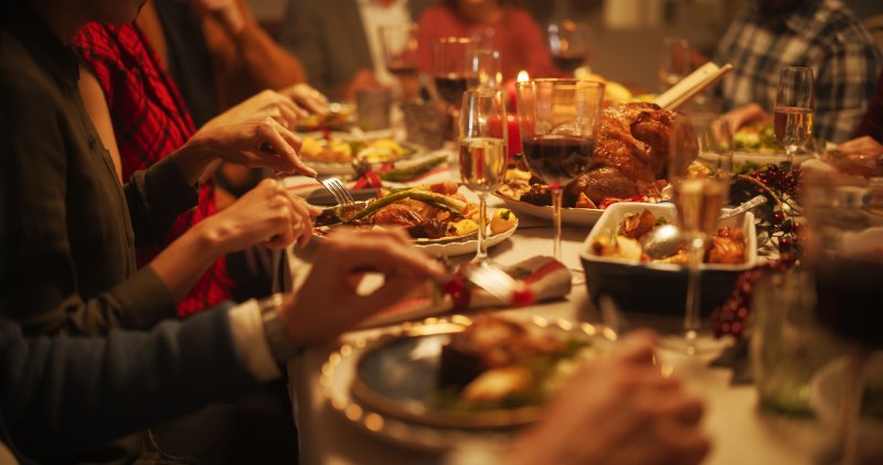 A family with good oral health gathering for a holiday dinner