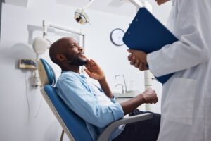 Man talking to dentist.