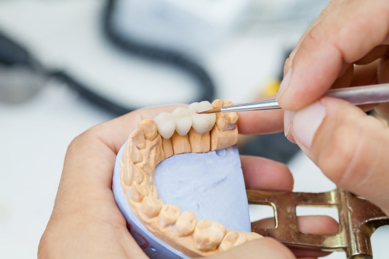 Dental technician working on dental crowns